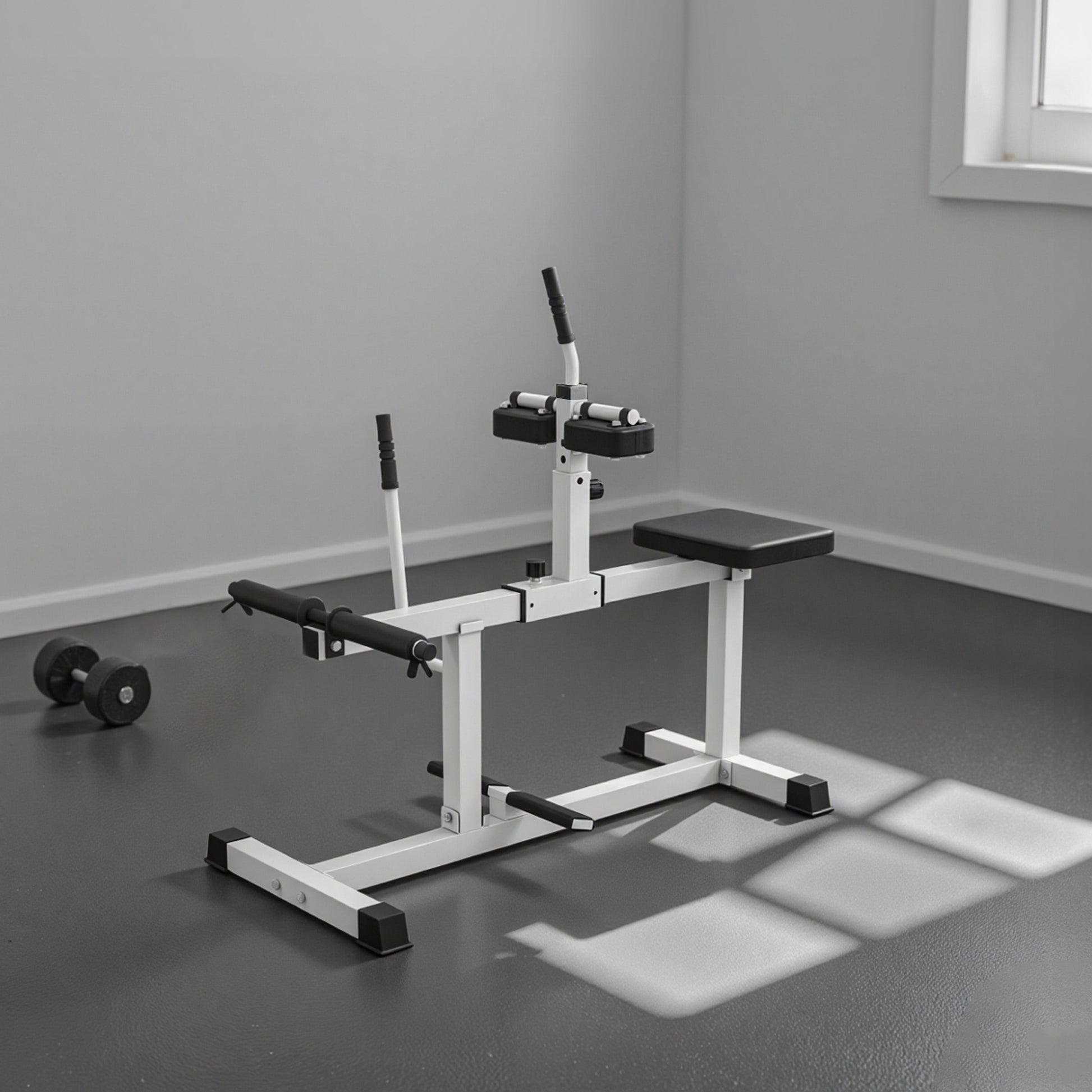 Gym bench with weight plates on a gray floor in a room.