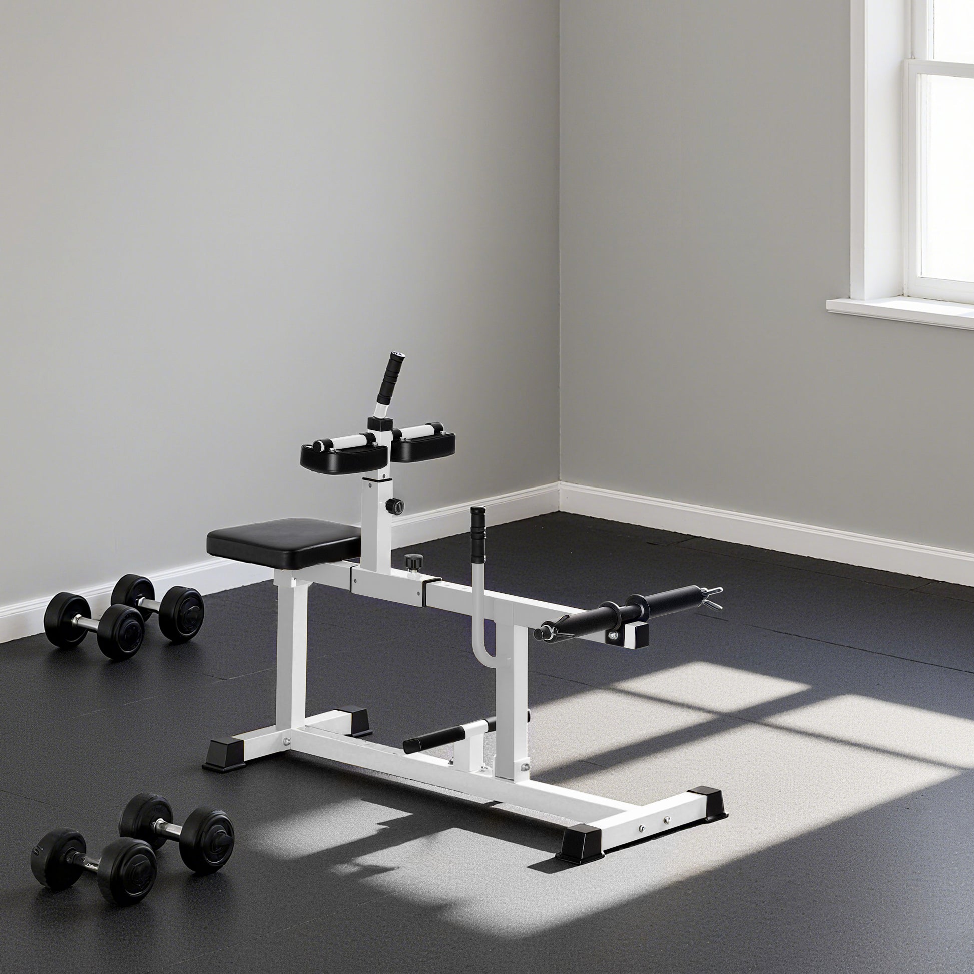 Gym bench with weights in a room with gray walls and a window.
